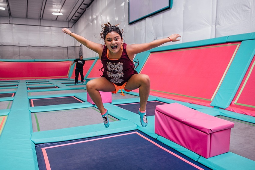 Girl smiling and jumping on Trampoline Park