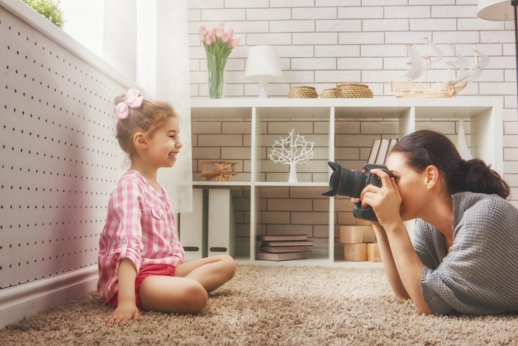 Mom Photographer in motion taking picture of child