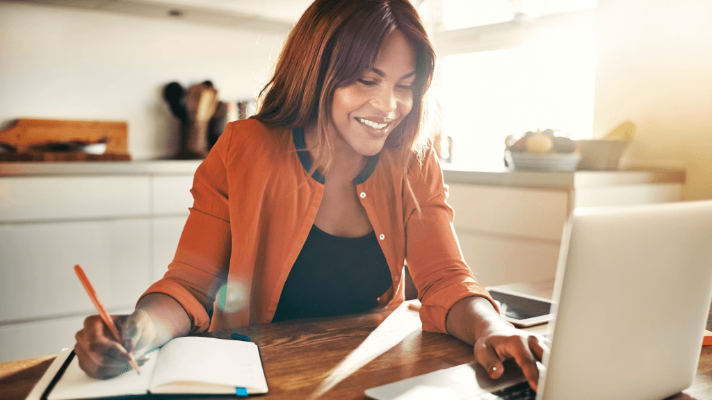 woman smiling looking at laptop