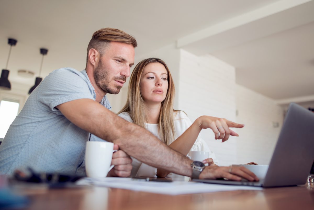 Adult worried couple calculating budget