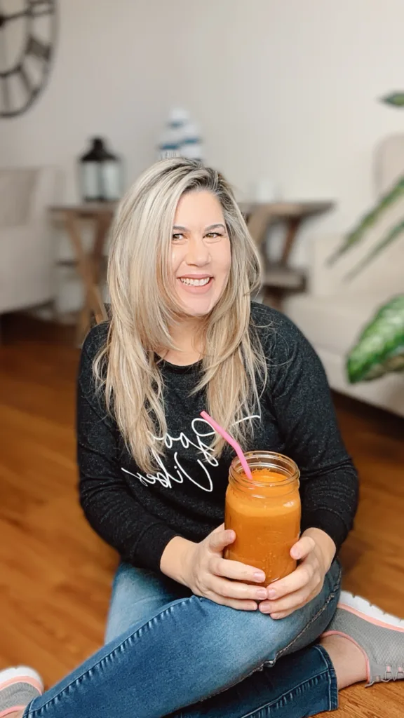 Fab Kellum holding sunshine juice - juicing my way back to health