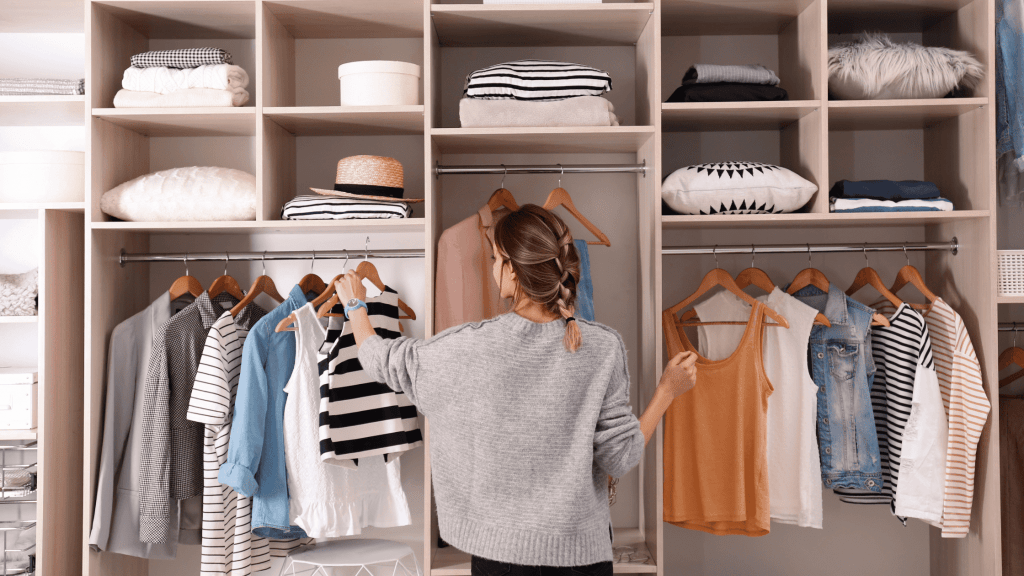woman picking clothing from her closet
