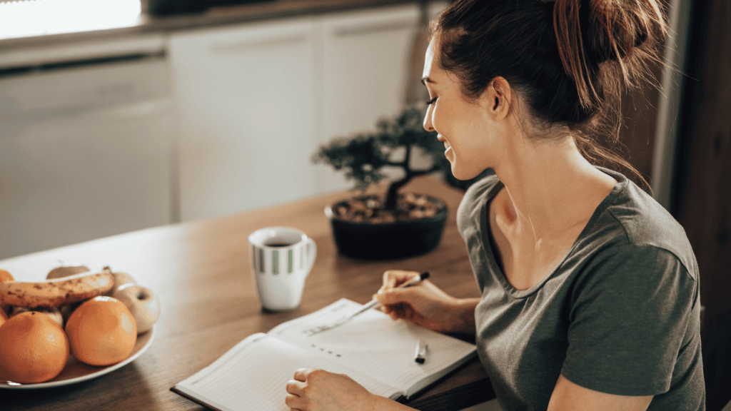 woman writing on notebook