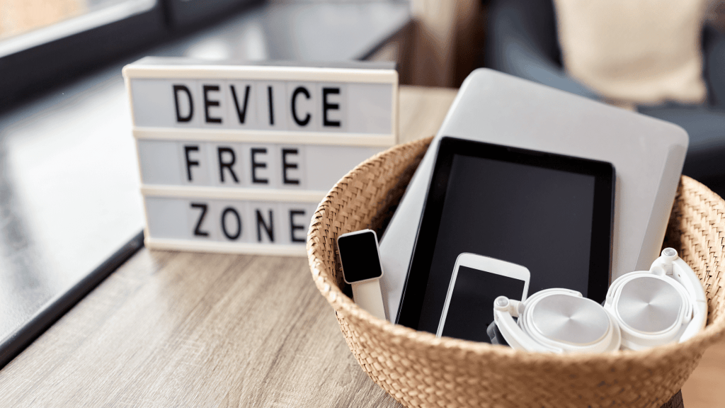Electronics in a basket near a device free zone sign