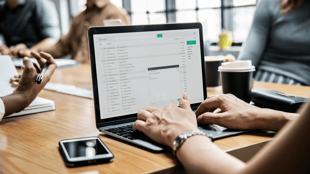 person working on email during meeting